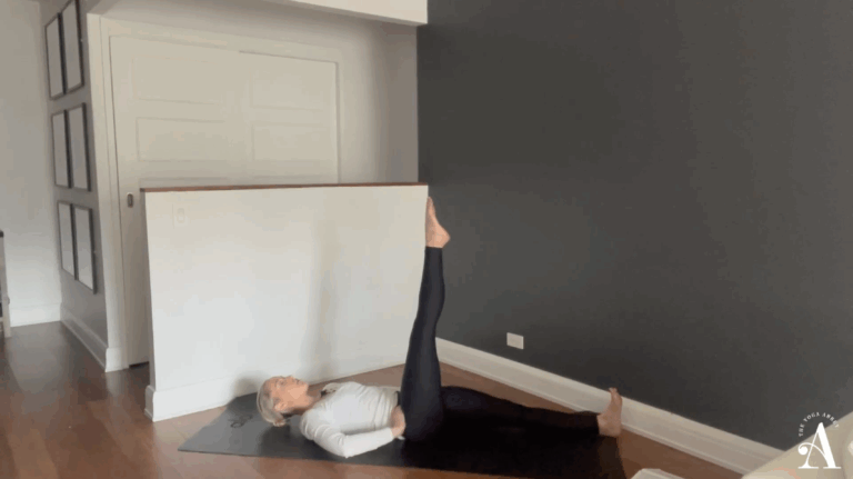 Elizabeth Miller supine with one leg extended to the sky